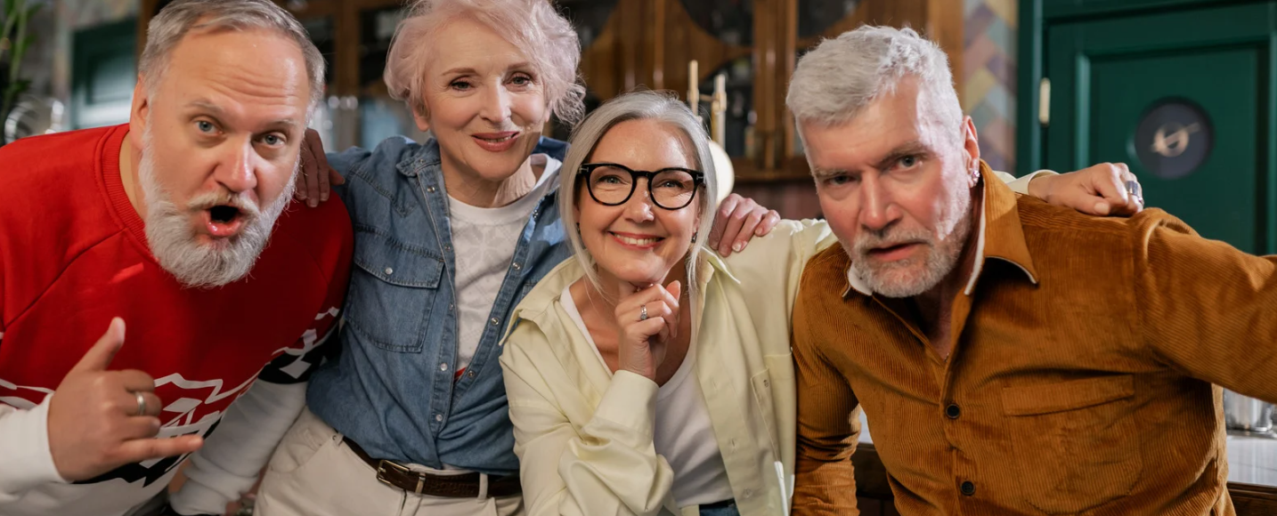 Seniors smiling and posing together during the Golden Days Out – Senior Stay and Play Package Red Deer at Red Deer Resort & Casino